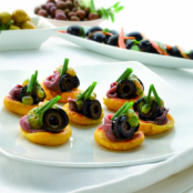 Spanish Corn cakes with tomato and olives