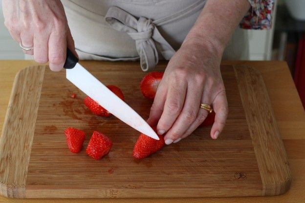 Cut the rest of the strawberries for the coulis