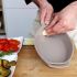 Rub casserole dish with the garlic