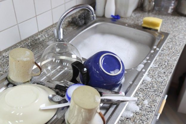 Heaps of dishes drying on the counter