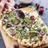 Grilled cherry, goat cheese, and arugula pizza