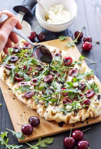 Grilled cherry, goat cheese, and arugula pizza