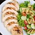 Sliced chicken over zucchini pasta and veggies