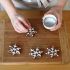 Add the edible silver sprinkle balls to each snowflake