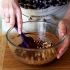 Add some of the nuts to the Nutella chocolate