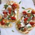 Grilled Pizza with Sausage Peppers Roasted Tomatoes and Mozzarella