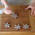 Pour the icing into a pastry bag made for writing, then decorate the cookies with snowflakes