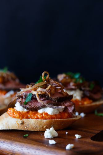 Filet Mignon Crostini with Romesco, Goats Cheese, and Crispy Shallot