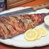 Baked bacon-wrapped mackerel with fresh herbs