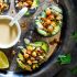 Mediterranean grilled avocado stuffed with chickpeas and tahini