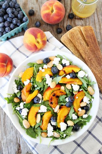 Grilled peach, blueberry and goat cheese arugula salad