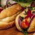 Loaded hot dogs on sesame buns