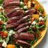 Arugula skirt steak salad with caramelized pears, pecans and gorgonzola