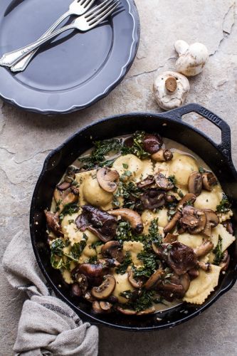 Taleggio ravioli in garlicky butter, kale and mushroom sauce with toasted pine nuts